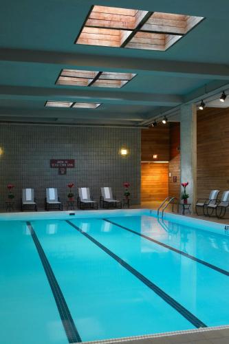 a swimming pool with blue water in a building at Des Moines Marriott Downtown in Des Moines