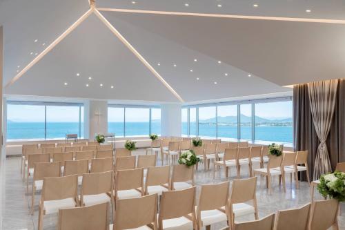 a banquet hall with chairs and tables and the ocean at Lake Biwa Marriott Hotel in Moriyama