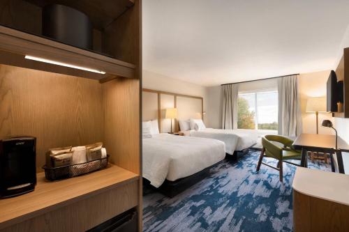a hotel room with two beds and a window at Fairfield Inn & Suites by Marriott Boulder Longmont in Longmont