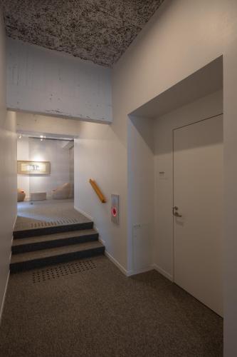 a room with a bed and a staircase in it at TSUCHIYA Kinosaki onsen in Toyooka