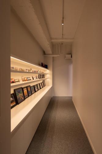 a hallway with paintings on display in a building at TSUCHIYA Kinosaki onsen in Toyooka