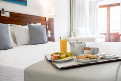 Postel nebo postele na pokoji v ubytování Hotel Praia