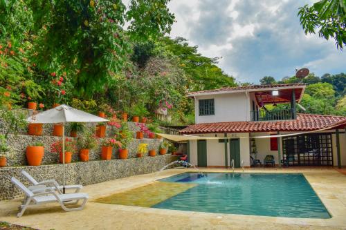 a villa with a swimming pool and a house at Espectacular finca Familiar en sopetran Antioquia in Sopetran