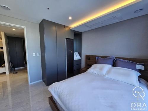Un dormitorio con una gran cama blanca con almohadas azules. en 서초 Luxury flat, en Seúl