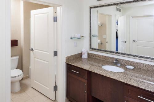 a bathroom with a sink and a toilet and a mirror at Residence Inn by Marriott Franklin Cool Springs in Franklin