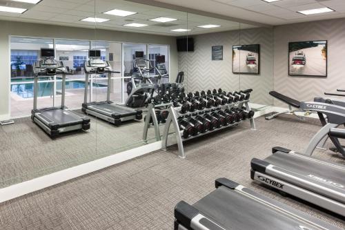 a gym with tread machines and a swimming pool at Residence Inn by Marriott Franklin Cool Springs in Franklin