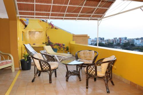 a group of chairs and tables on a balcony at O Jardim do Vinho, AC in Praia