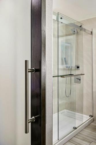 a shower stall with a glass door in a bathroom at Ventura Beach Marriott in Ventura