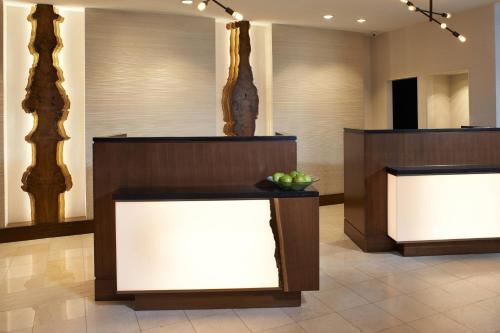 a lobby with two reception desks with white lights at Detroit Metro Airport Marriott in Romulus