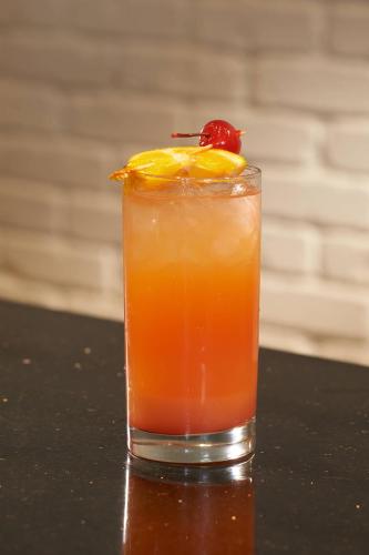 a drink with a cherry on top of a table at Detroit Metro Airport Marriott in Romulus