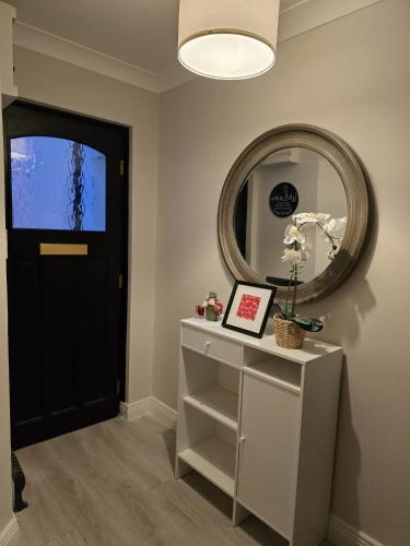 a hallway with a black door and a mirror at Dublin - 3 Bedroom Cosy Home - Sleeps Max 7 in Dublin