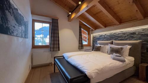 a bedroom with a large bed in a room at Daphné Heights by Villars Luxury in Villars-sur-Ollon