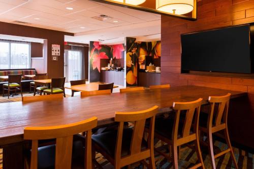 a conference room with a large wooden table and chairs at Fairfield Inn & Suites by Marriott Utica in Utica