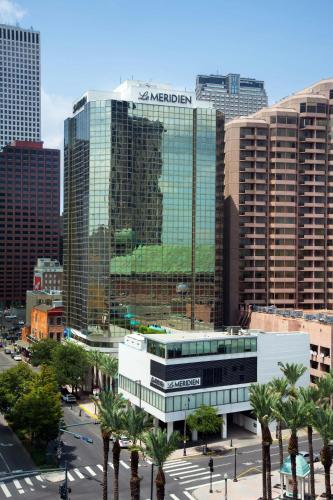 a view of a city with tall buildings and palm trees at Le Meridien New Orleans in New Orleans