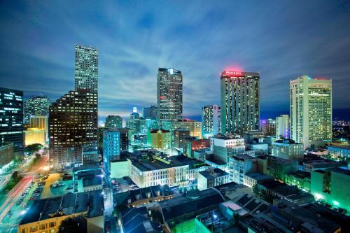 a city skyline at night with lit up buildings at Le Meridien New Orleans in New Orleans