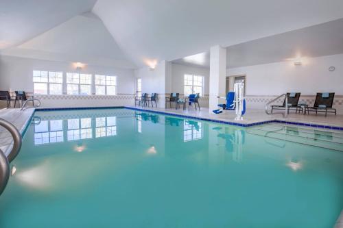 a large swimming pool with blue water in a building at Residence Inn Boise West in Boise