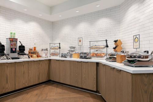 a restaurant with a counter with food on it at Fairfield Inn by Marriott Visalia Sequoia in Visalia