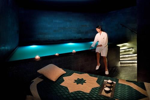a man standing on a wall next to a bed at JW Marriott Marquis Hotel Dubai in Dubai
