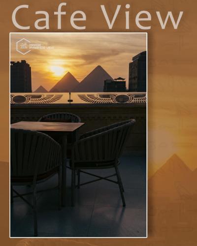 a magazine cover for a cafe view with a table and chairs at Mirage pyramids view hotel in Cairo