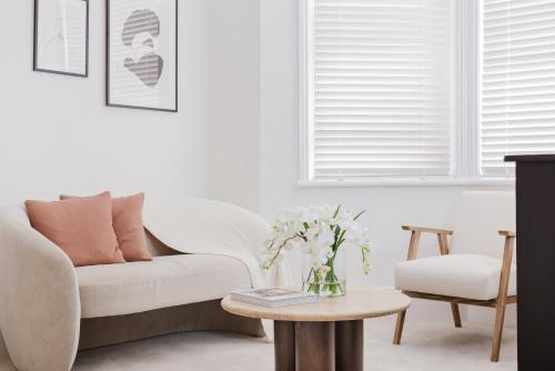 a living room with a couch and a table at Cosy Charming Apartment in Central London in London