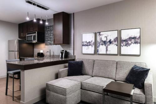 a living room with a couch and a kitchen at Residence Inn by Marriott Boston Logan Airport/Chelsea in Chelsea