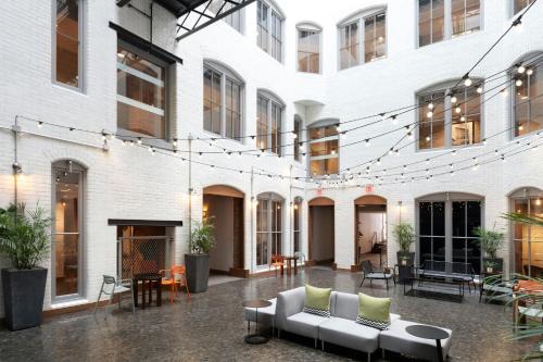 a courtyard of a building with a couch and chairs at Residence Inn by Marriott Boston Downtown Seaport in Boston