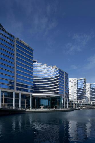 a large building next to a body of water at Marriott Marquis Dubai Creek in Dubai