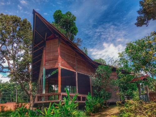 a wooden house in the middle of a forest at Bagas Zakariah Orchard Lodge in Gopeng