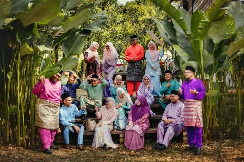 a group of people posing for a picture at Bagas Zakariah Orchard Lodge in Gopeng