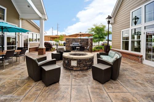 an outdoor patio with chairs and a fire pit at Residence Inn by Marriott Springfield Chicopee in Chicopee