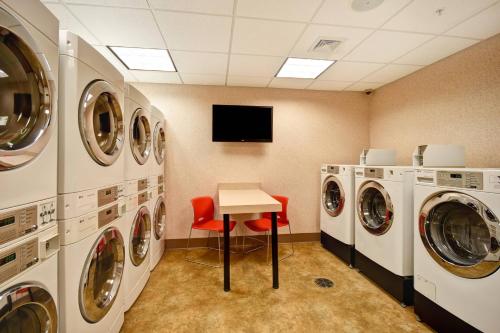 a laundry room with a table and washing machines at Residence Inn by Marriott Springfield Chicopee in Chicopee