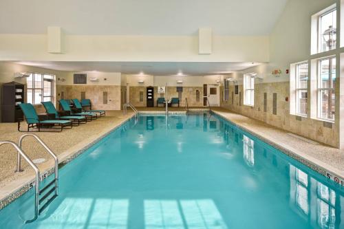 a large swimming pool with blue water at Residence Inn by Marriott Springfield Chicopee in Chicopee
