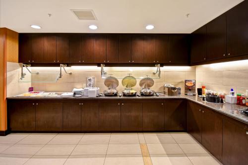 a kitchen with wooden cabinets and a counter top at Residence Inn by Marriott Springfield Chicopee in Chicopee