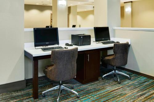 an office with two computers on a desk with two chairs at Residence Inn by Marriott Bangor in Bangor