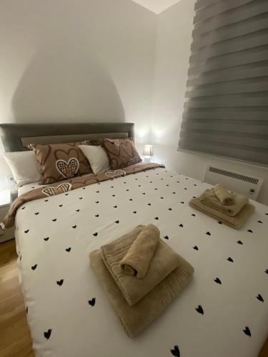 a bedroom with a large bed with towels on it at El Placer in Zlatibor