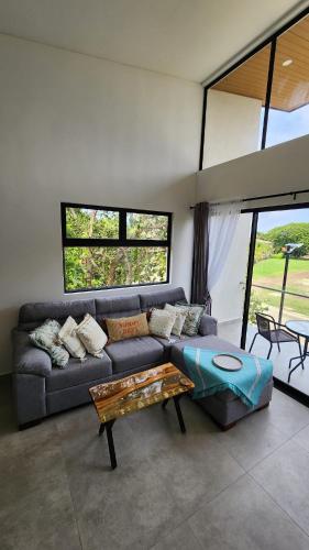 a living room with a couch and a table at Sunny 2-bed condo - fast WIFI in Puntarenas