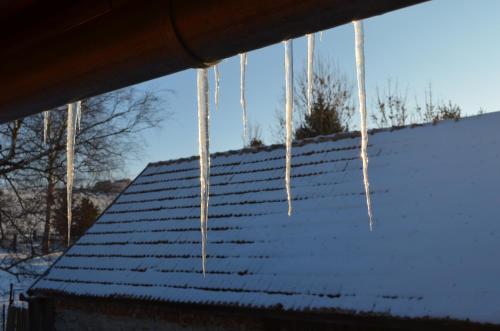 icicles hanging from the roof of a house at Mária Kičáková TATRY MKS in Štrba