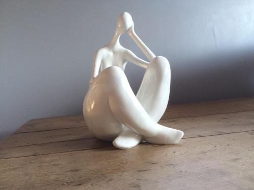 a white figurine of a woman sitting on a table at B&B Le Mas Des Chenes in Vacquières