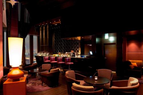 a bar with chairs and tables in a room at JW Marriott Hotel Ankara in Ankara
