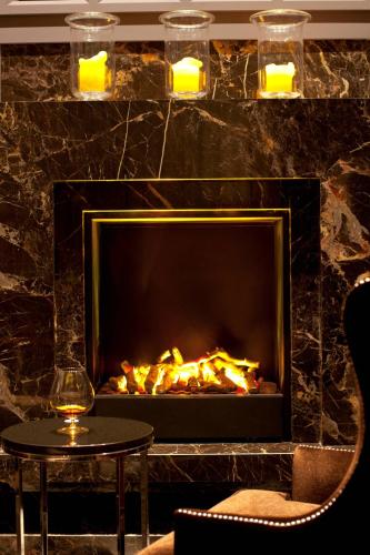 a fireplace in a room with a table and a wine glass at JW Marriott Hotel Ankara in Ankara