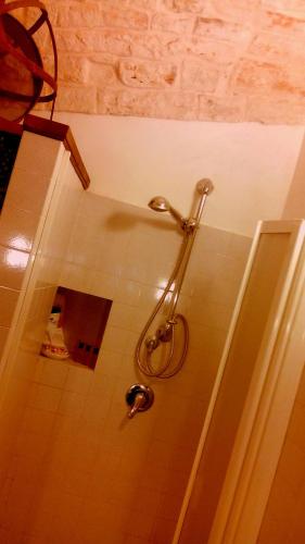 a shower in a bathroom with a glass wall at Miratrulli Apartment & Trullo dell'Aia in Alberobello