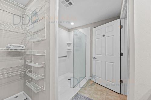 a walk in closet with a glass door at Legacy Tower I 302 in Gulfport