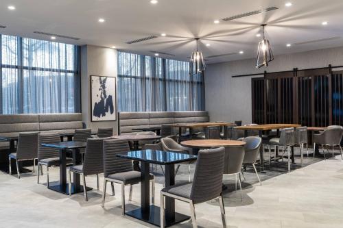 a restaurant with tables and chairs and windows at Residence Inn Boston Downtown/South End in Boston