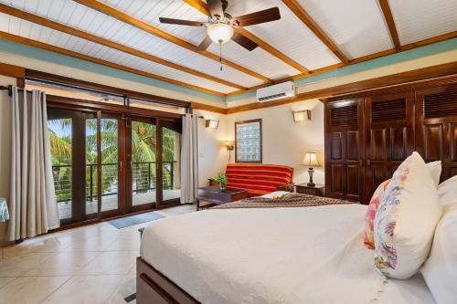 a bedroom with a bed and a ceiling fan at Buttonwood Belize in Hopkins