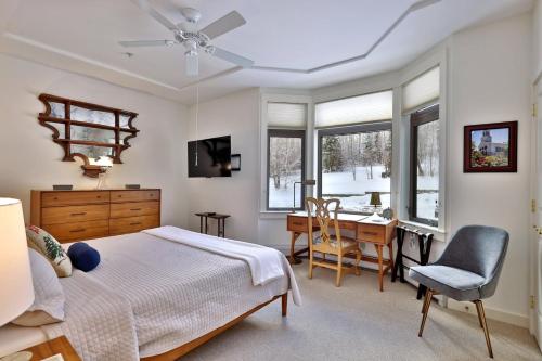 a bedroom with a bed and a desk and a chair at Lodges at Sunrise 3BR 3BA Luxury Ski On Ski Off Condo, Pool, Hot Tub, Gym, Sports Center in Killington