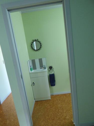 a door leading into a room with a small refrigerator at Lowlands Holiday Home in Waihi