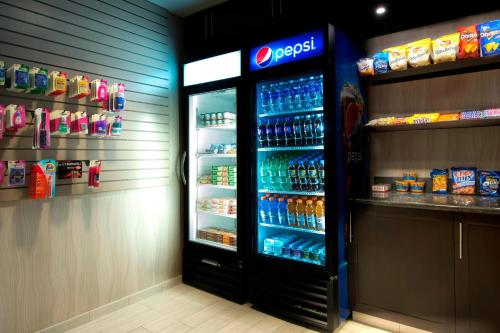 a soda refrigerator in a store with drinks in it at Residence Inn Worcester in Worcester