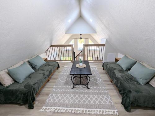 a living room with a couch and a table at Luxury Cabin in The Country With King Bed and Loft #1 in Point