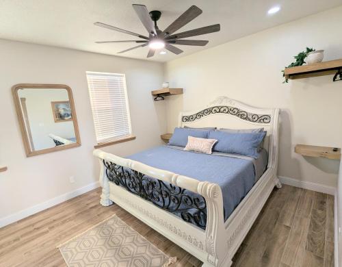 a bedroom with a bed with a ceiling fan at Luxury Cabin in The Country With King Bed and Loft #1 in Point