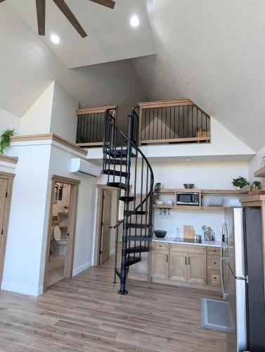 a kitchen with a spiral staircase in a house at Luxury Cabin in The Country With King Bed and Loft #1 in Point